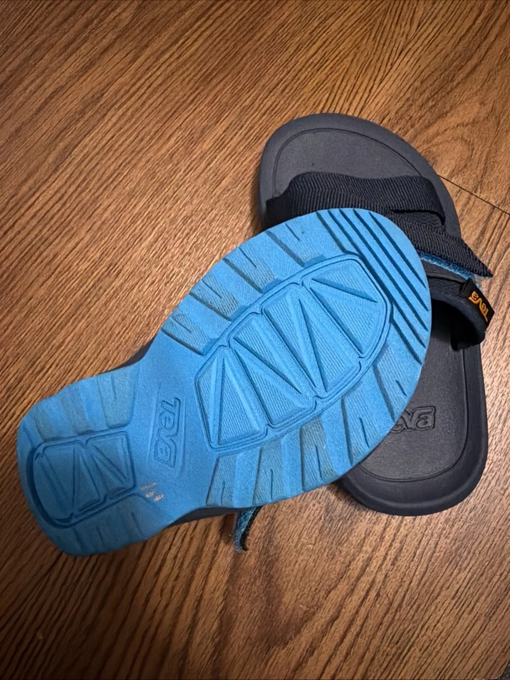 Teva Black Slide Sandals with Blue Accent